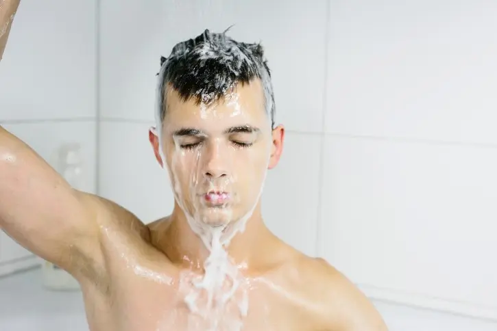 Man rinsing his hair